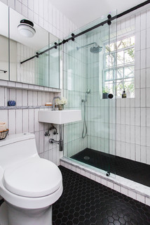 black hex floor tile, built-in alcove shelf, glass sliding shower door