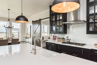 black and white interior, black cabinets with inset subway tiles, black glass paneled cabinet doors